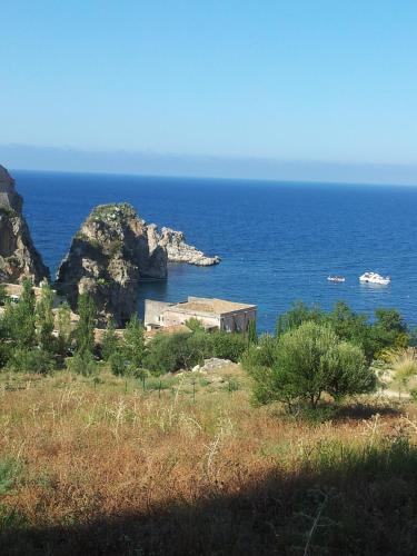 a house on a hill near the ocean at Palms Villa in Scopello