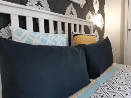 a bedroom with a bed with pillows on it at Il Piccolo B&B in Fiumicino