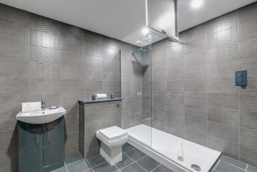 ein Bad mit einem WC, einem Waschbecken und einer Dusche in der Unterkunft Harrisons Aparthotel Liverpool in Liverpool