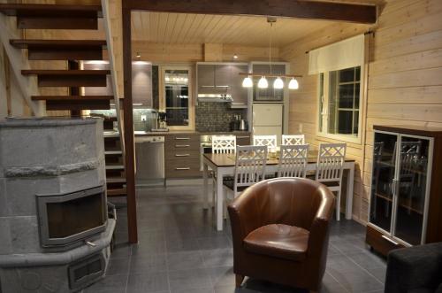 uma cozinha e sala de jantar com uma mesa e um fogão em Vanamo em Ylläsjärvi