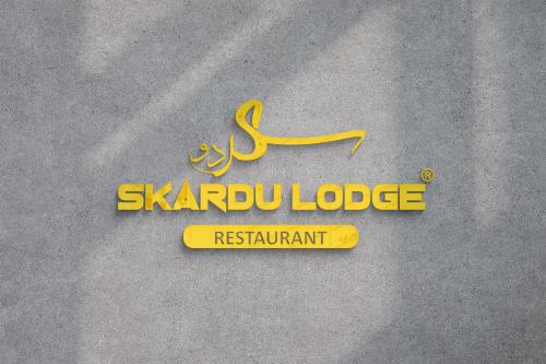 a sign for a saudi logo on a wall at Skardu Lodge in Skardu