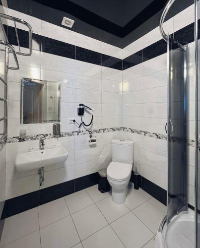 a bathroom with a toilet and a sink at Viktan Hotel in Bukovel