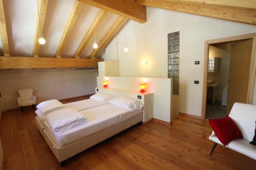 a bedroom with a large bed in a room with wooden ceilings at Enclos de Moro - Apartments Berthod in Courmayeur