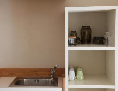 a kitchen with a sink and a shelf at Enclos de Moro - Apartments Berthod in Courmayeur
