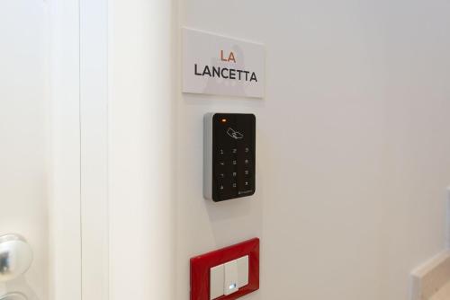 a remote control on the wall of a bathroom at La Retara Affittacamere in San Benedetto del Tronto