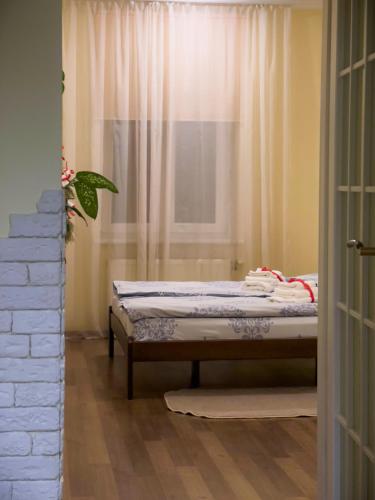 a bed sitting in a room with a window at Homey apartment on Vicheva Str. in Lviv