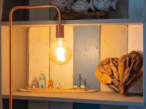 a light on a shelf with a house on it at Finest Retreats - Old Harbour Cottage in Mevagissey