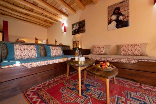 a living room with a couch and a table at Touda Ecolodge Atlas Mountains in Zawyat Oulmzi