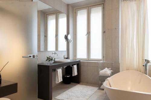 a bathroom with a tub and a sink and a mirror at Elite Hotel Stockholm Plaza in Stockholm