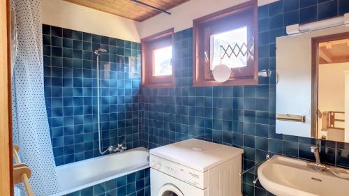 a blue tiled bathroom with a sink and a washing machine at APPARTEMENT ACCES PISICNE - ST JEAN D'AULPS - 6 Pers - Riam D2 in Saint-Jean-d'Aulps