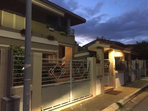 a house with a gate in front of it at B&B Filomena in Santa Giusta