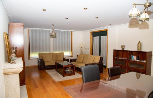 a living room with a couch and a table at A Lúa do Camiño in Melide
