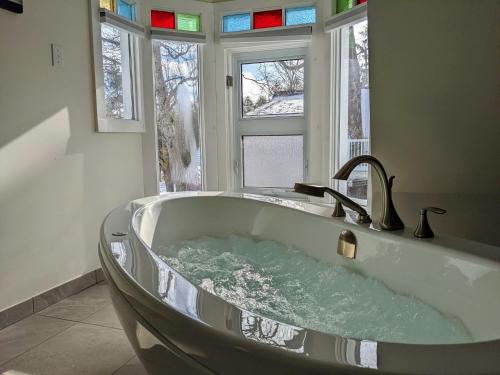 a bath tub in a bathroom with a window at Gingerbread House Inn - We Are Open - Winter, Spring, Summer and Fall in Wolfville