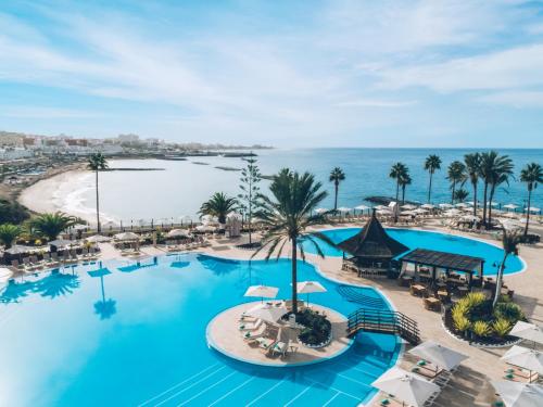 an overhead view of the pool at a resort with a beach at Iberostar Selection Anthelia in Adeje