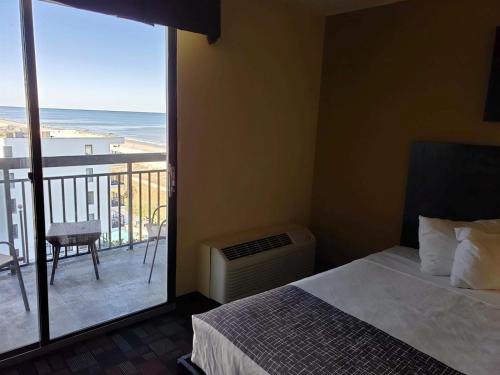 a bedroom with a bed and a view of the ocean at Ocean View Studio-Sun N Sand 603 in Myrtle Beach