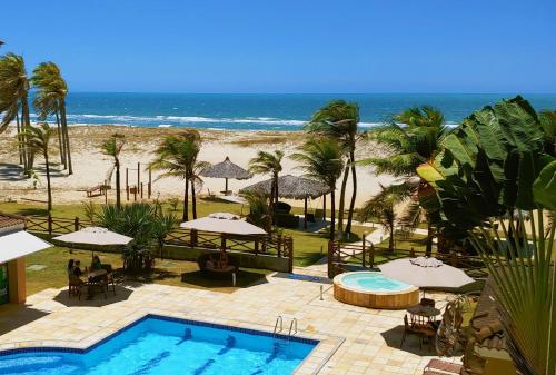a resort with a swimming pool and a beach at Atlantic Palace Family inn in Aquiraz