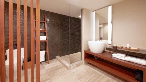 a bathroom with a wooden floor and wooden walls at Nobu Hotel at Caesars Palace in Las Vegas