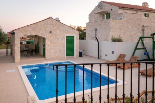a villa with a swimming pool and a house at Corte villas & apartments - AE1043 in Privlaka
