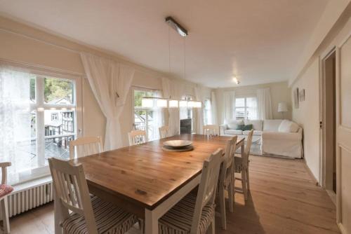 a dining room with a wooden table and chairs at Boutique Fachwerkhaus Thirty Five in Monschau
