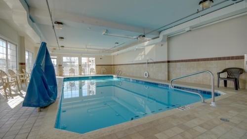 a large swimming pool in a room with a large pool at Americana Condos 10th street in Ocean City