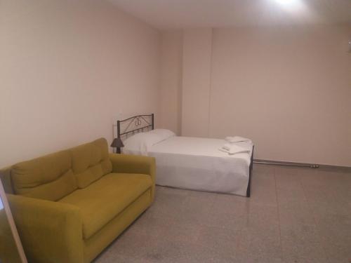 a living room with a couch and a bed at Nereids Apartments-Pronoe in Petalidi