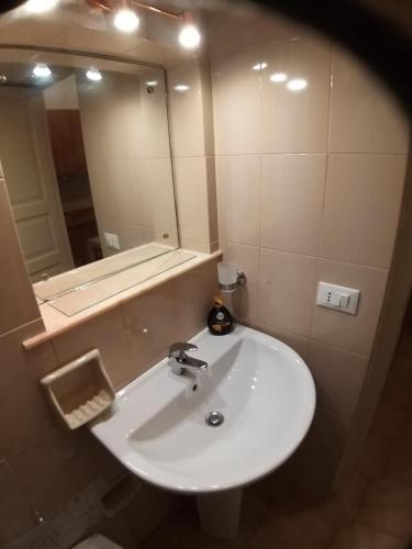 a bathroom with a white sink and a mirror at casa torre di ligny in Trapani