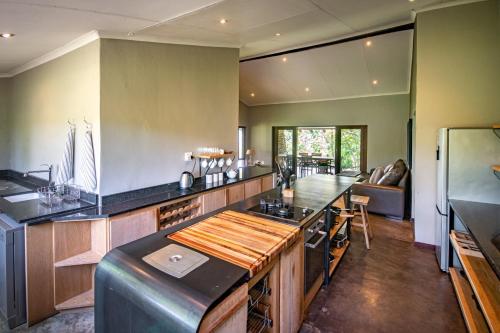 a large kitchen with a counter top and a stove at Summerfields Rose Retreat and Spa in Hazyview