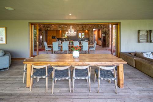 a wooden table and chairs in a living room at Summerfields Rose Retreat and Spa in Hazyview