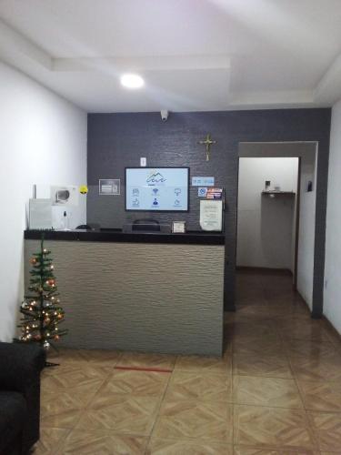 a lobby with a christmas tree on a counter at Pousada Maré Mansa in Maceió