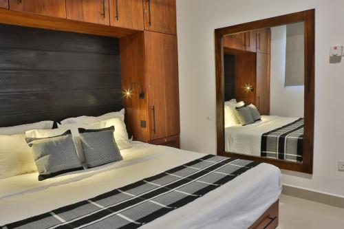 a bedroom with two beds and a large mirror at 007 Colombo in Colombo