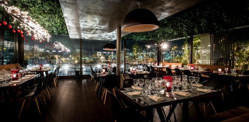 a restaurant with tables and chairs with lights at Philippos Xenia Hotel in Serres