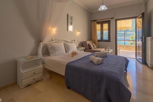 a bedroom with a large bed and a couch at pension holidays studios in Vasiliki