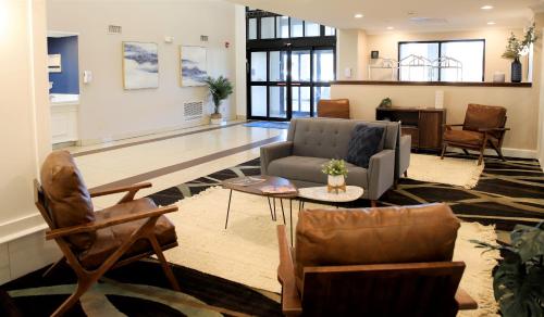a living room with a couch and chairs and a table at Baymont by Wyndham Jackson/Ridgeland in Jackson