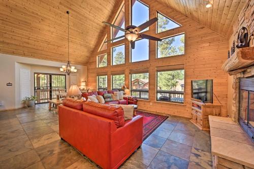 a living room with a ceiling fan and a fireplace at Deck, BBQ and Fireplace Family Cabin in Show Low! in Show Low