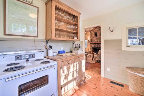 a kitchen with a stove and a white oven at Mirror Lake Cabin about 1 Mi to Dtwn Highlands! in Highlands