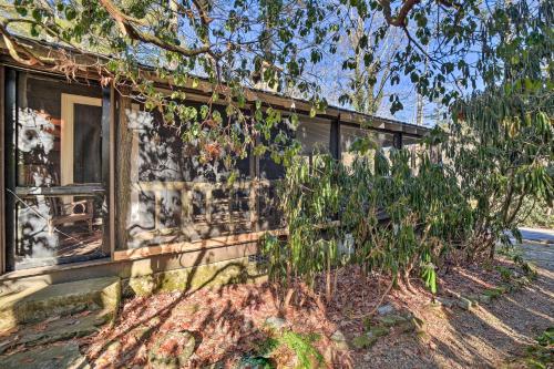 a building with graffiti on the side of it at Mirror Lake Cabin about 1 Mi to Dtwn Highlands! in Highlands