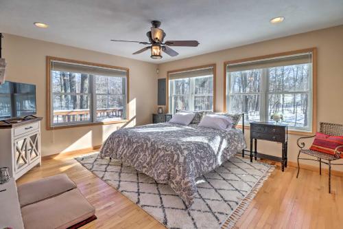 a bedroom with a bed and a ceiling fan at Deck, Pool, Trails Access Pocono Family Home! in Albrightsville