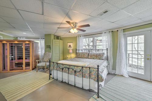 a bedroom with a bed and a ceiling fan at Scenic Pet-Friendly House with Private Hot Tub! in Waynesville