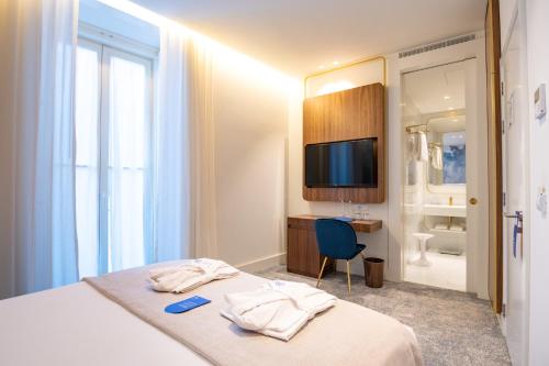 a white bathroom with a white sink and a white refrigerator at Blue Liberdade Hotel in Lisbon