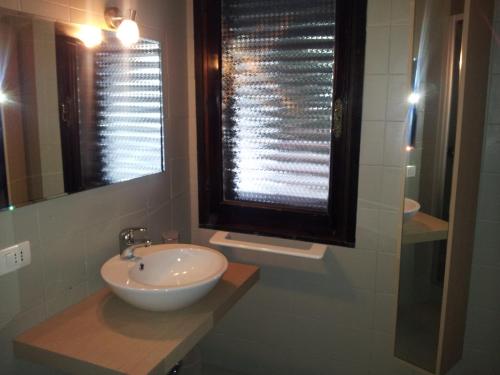 a bathroom with a sink and a window at Villa Francesca in Flumini di Quartu