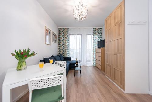a living room with a couch and a table with a television at Apartamenty Centrum II in Bydgoszcz