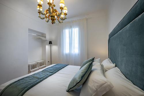 una camera da letto con un letto grande con un lampadario di JCL first apt in the hearth of Florence a Firenze