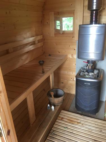 a inside of a wooden sauna with a bucket at Ezermāja "Spārītes" in Geraņimova