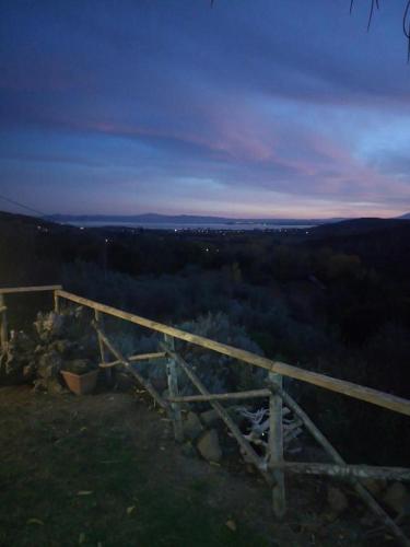 a view of a forest with a wooden fence at casaemilia2 in Tuoro sul Trasimeno