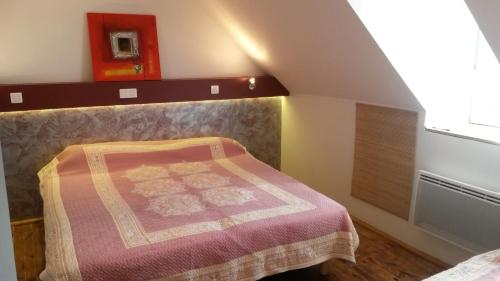 a bedroom with a bed and a window at Hôtel Armony in Laissac