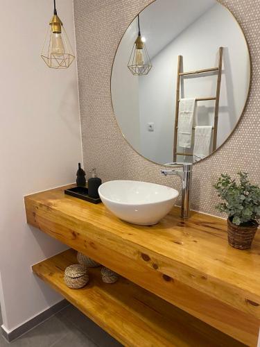 a bathroom with a sink and a mirror at Seixal Old Town River View Apartment in Seixal