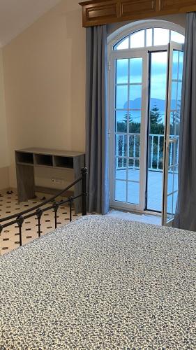 a bedroom with a bed and a large window at Ocean Front View in Angra do Heroísmo