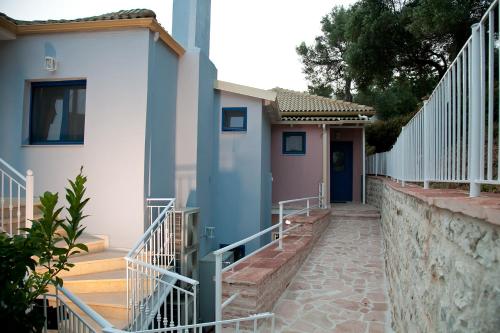 a house with a staircase next to a building at Villa Niki in Plataria