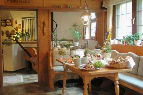 a dining room with a table with food on it at Landhaus Preißinger in Warmensteinach