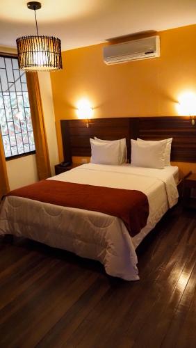 Una cama o camas en una habitación de Manish Hotel Ecólogico